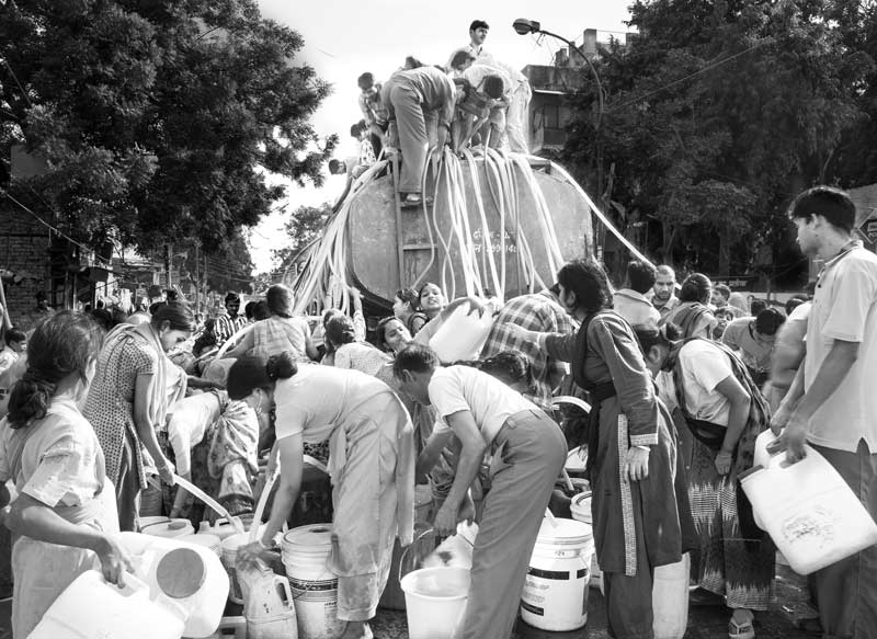 Rush for drinking water at a water tanker in South-East district, National Capital Territory of Delhi